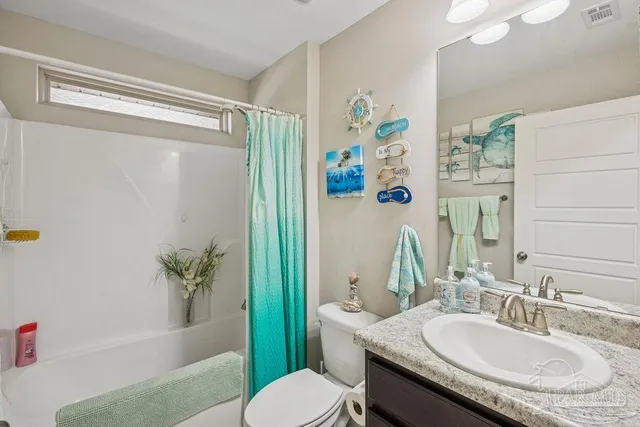 a bathroom with a granite countertop sink toilet a mirror and a shower