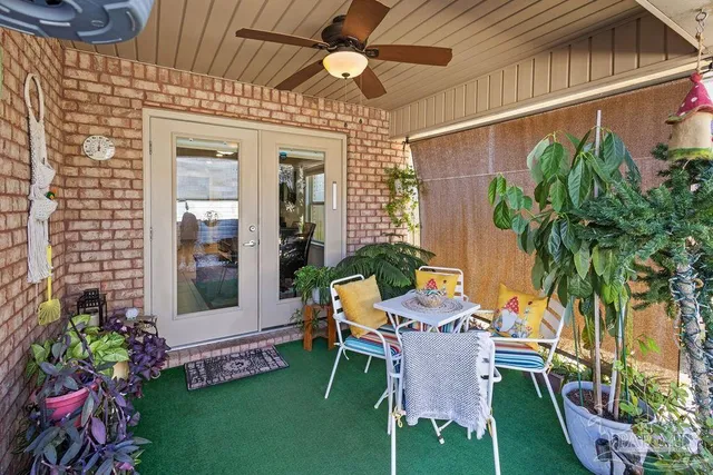 a view of a patio with table and chairs and potted plants