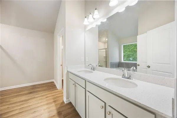 a bathroom with a sink double vanity granite and a mirror