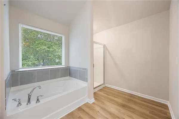 a bathroom with a bathtub and a window