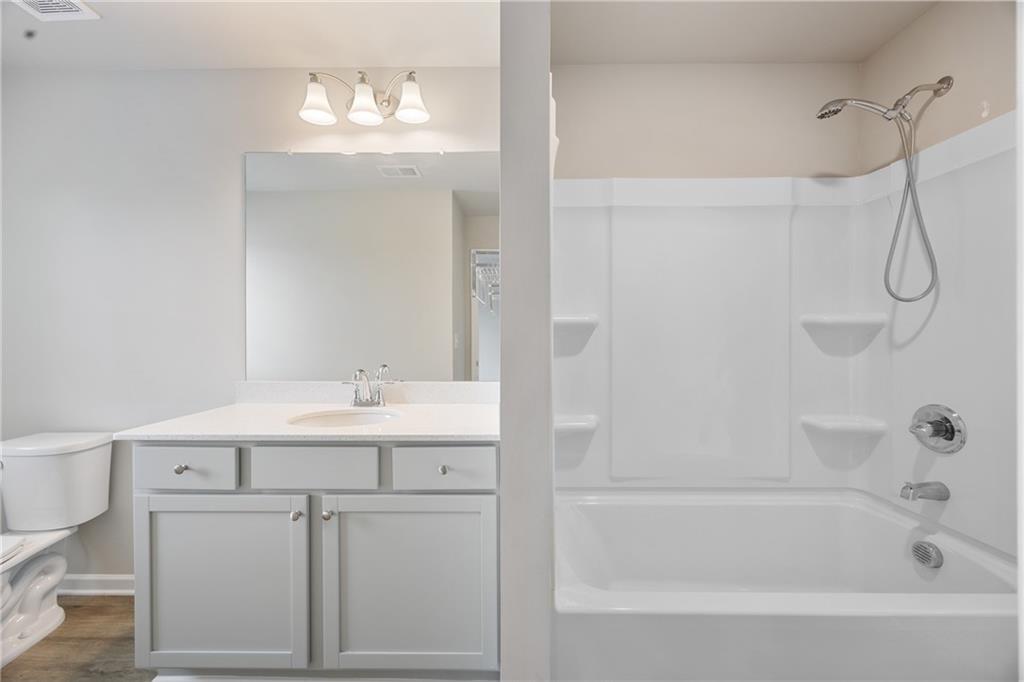 116 Cabin Way Hampton, GA 30228 - Photo 27 of 32 a bathroom with a sink and a mirror