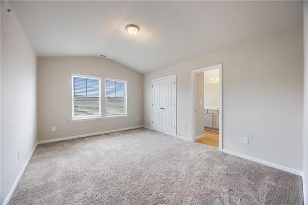 an empty room with windows and closet