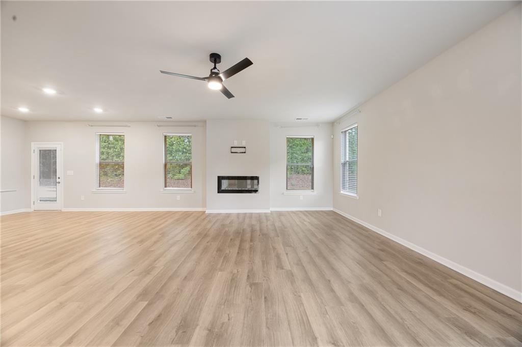 116 Cabin Way Hampton, GA 30228 - Photo 6 of 32 a view of empty room with wooden floor and fan