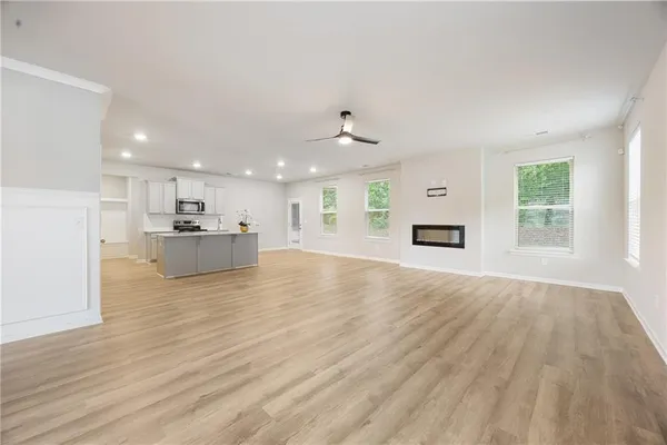 a view of kitchen and hall with wooden floor