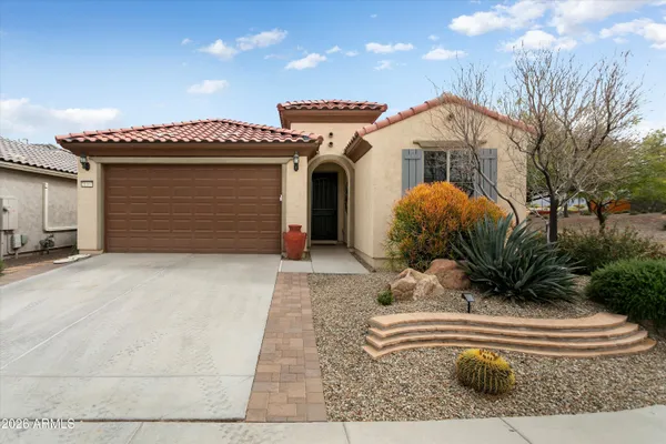 a front view of a house with a garden