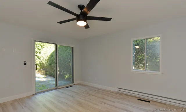 wooden floor in an empty room with a window