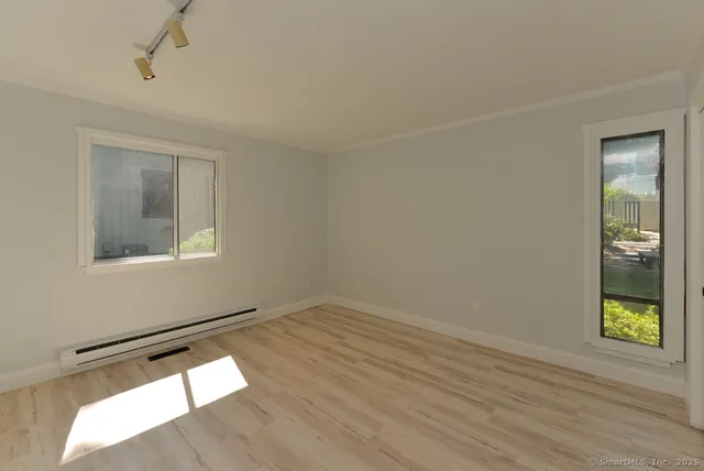 a room with a window and wooden floor