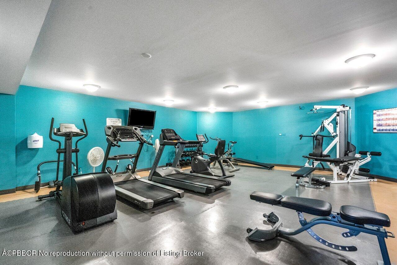 3120 South Ocean Boulevard, Unit 1502 Palm Beach, FL 33480 - Photo 24 of 26 a room with gym equipment and a flat screen tv