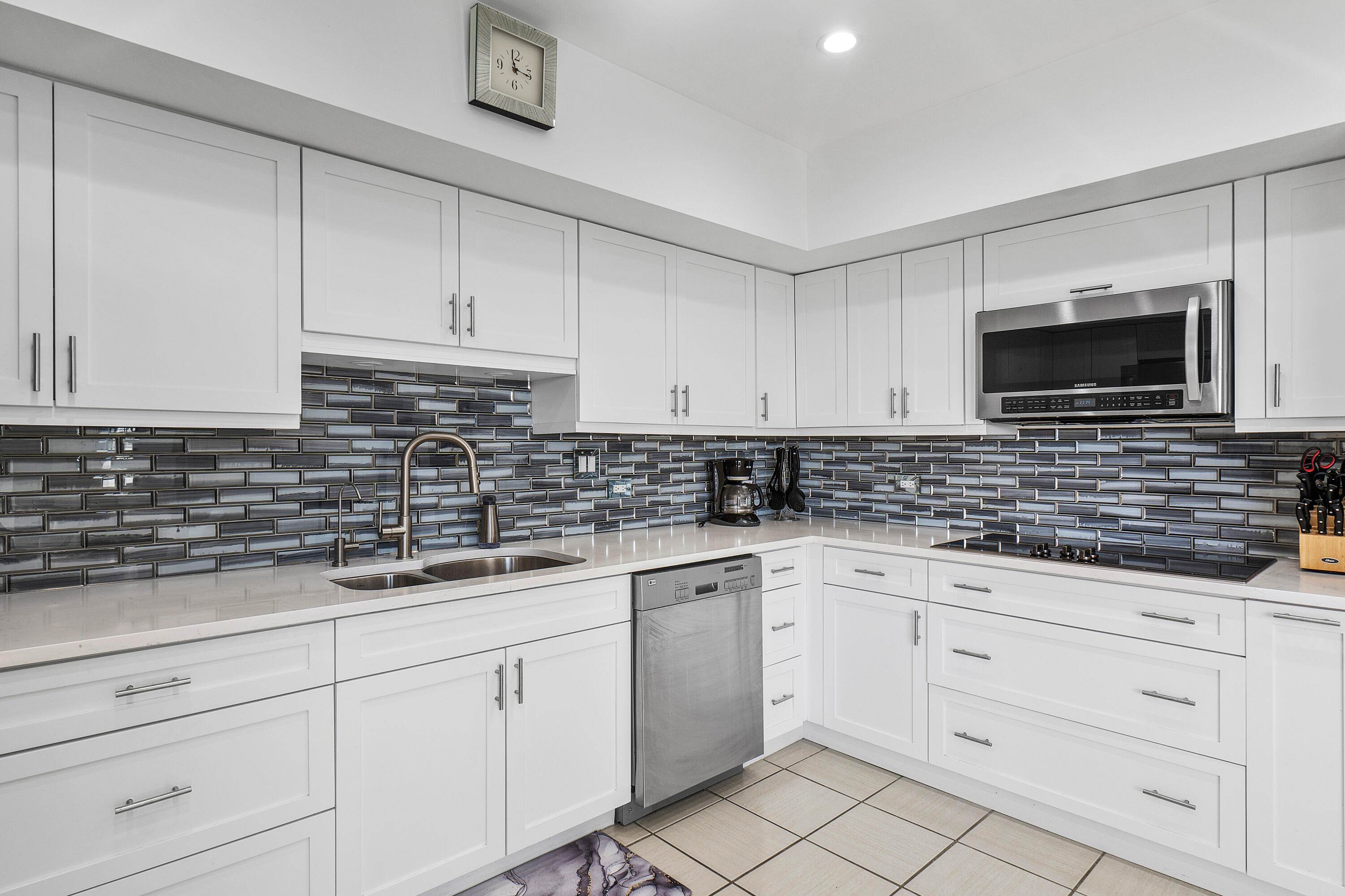 3120 South Ocean Boulevard, Unit 1502 Palm Beach, FL 33480 - Photo 6 of 26 a kitchen with white cabinets stainless steel appliances and a sink