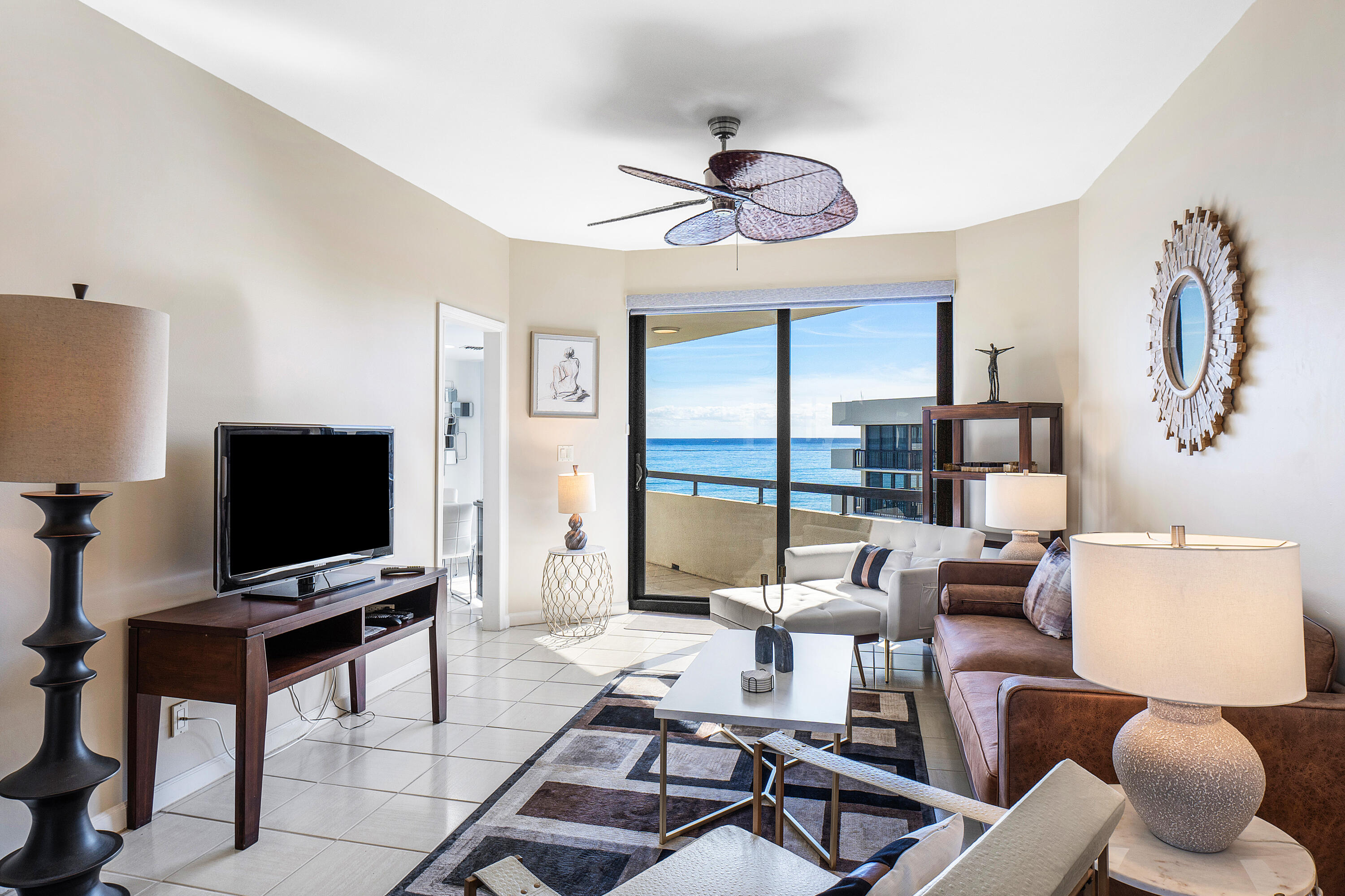 3120 South Ocean Boulevard, Unit 1502 Palm Beach, FL 33480 - Photo 8 of 26 a view of a livingroom with furniture and a flat screen tv