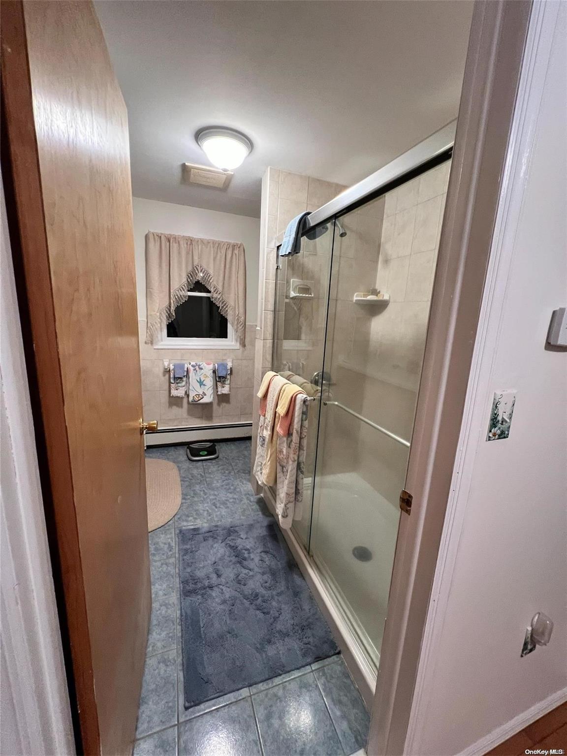 5 Lynncliff Road Hampton Bays, NY 11946 - Photo 15 of 31 a en suite bathroom with a shower a sink and a mirror