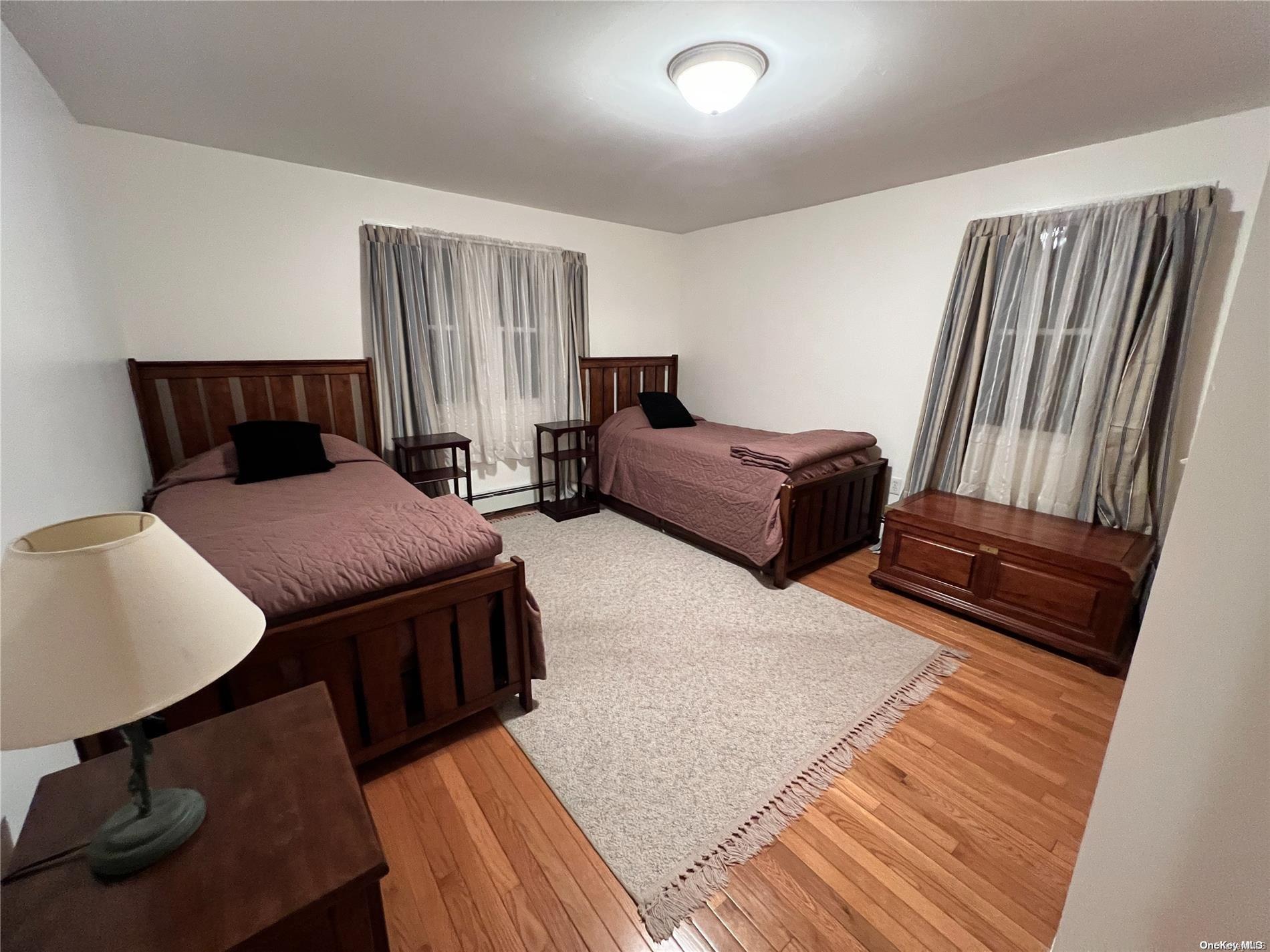 5 Lynncliff Road Hampton Bays, NY 11946 - Photo 17 of 31 a living room with furniture rug and wooden floor