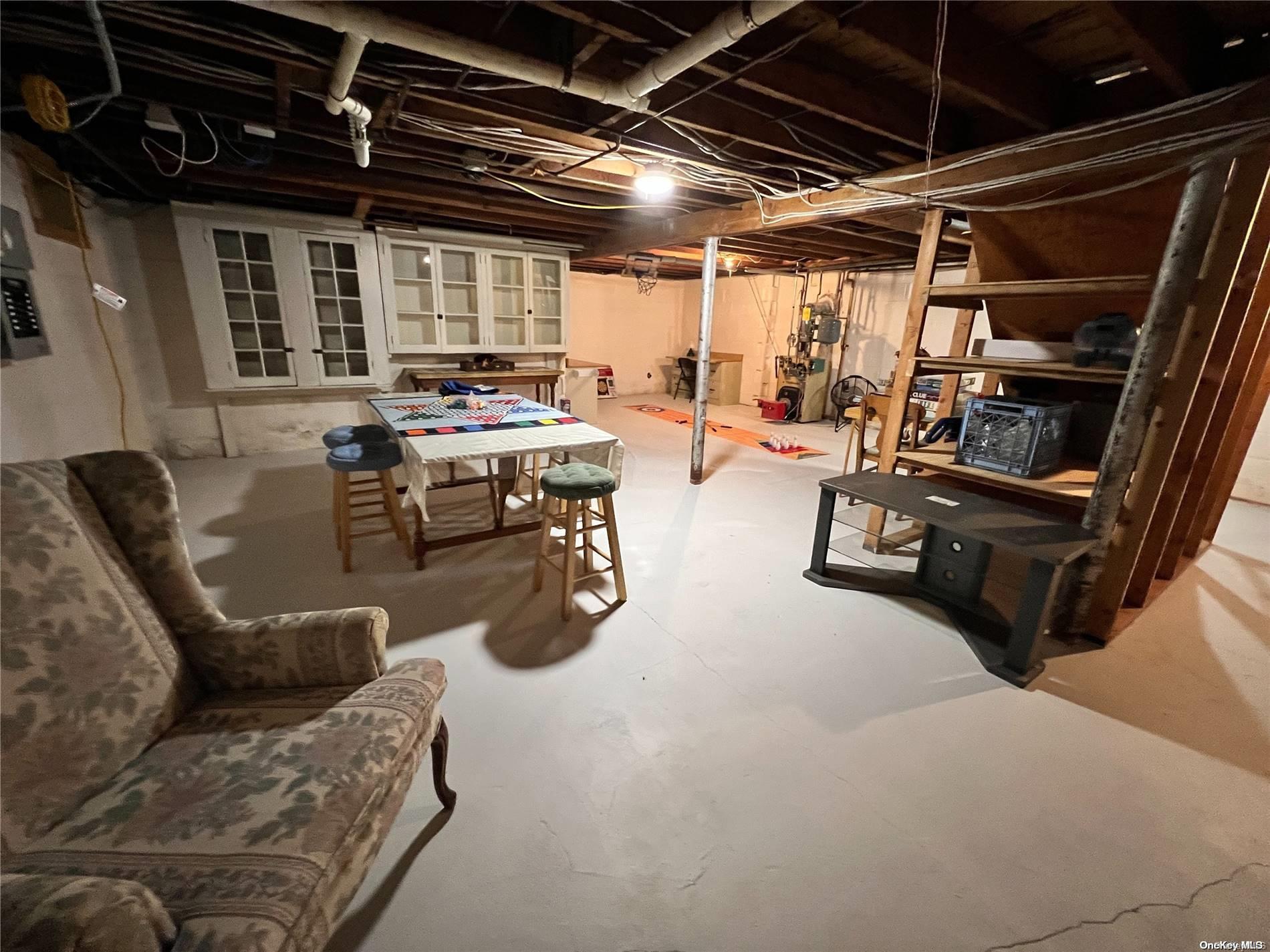5 Lynncliff Road Hampton Bays, NY 11946 - Photo 21 of 31 a gym room with furniture and a window