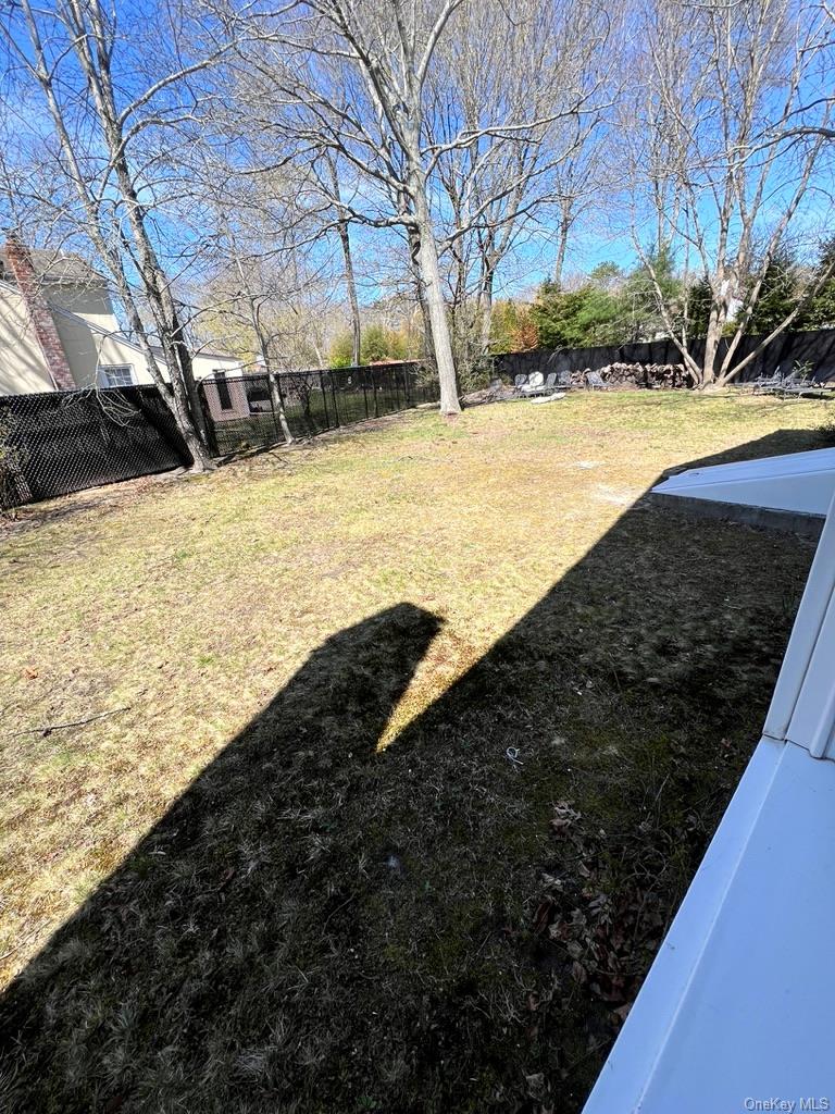 5 Lynncliff Road Hampton Bays, NY 11946 - Photo 30 of 31 a view of a yard with wooden fence