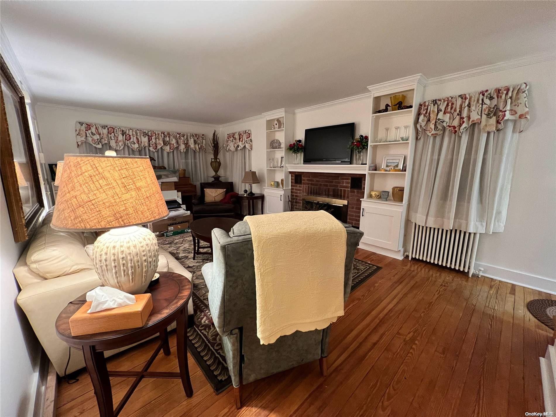 5 Lynncliff Road Hampton Bays, NY 11946 - Photo 7 of 31 a living room with furniture and a flat screen tv