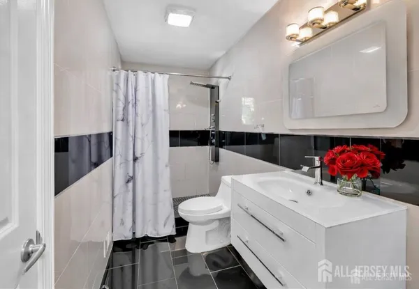 a bathroom with a sink a toilet and a mirror