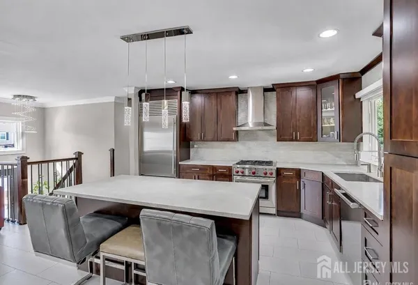 a kitchen with stainless steel appliances granite countertop a stove refrigerator sink and cabinets
