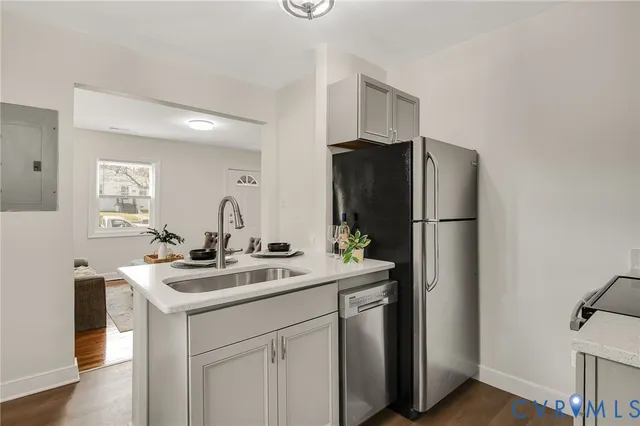 a kitchen with stainless steel appliances granite countertop a refrigerator and a sink