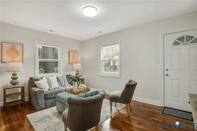 a living room with furniture and wooden floor