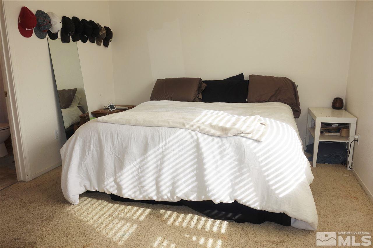 18470 Datewood Court Reno, NV 89508 - Photo 11 of 20 a bedroom with a bed and a lamp