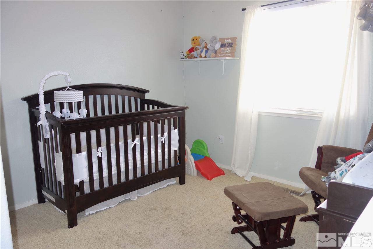 18470 Datewood Court Reno, NV 89508 - Photo 13 of 20 a bedroom with a bed and wooden floor