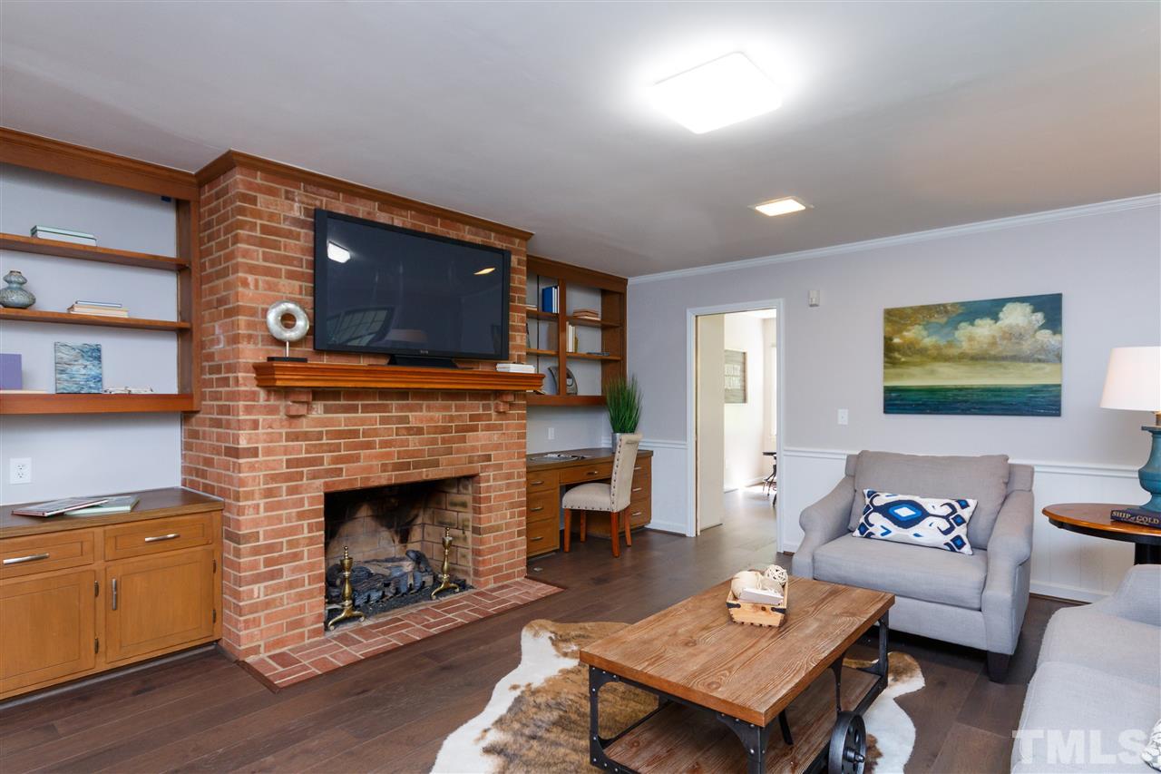 2911 Buckingham Road Durham, NC 27707 - Photo 13 of 25 a living room with furniture a flat screen tv and a fireplace