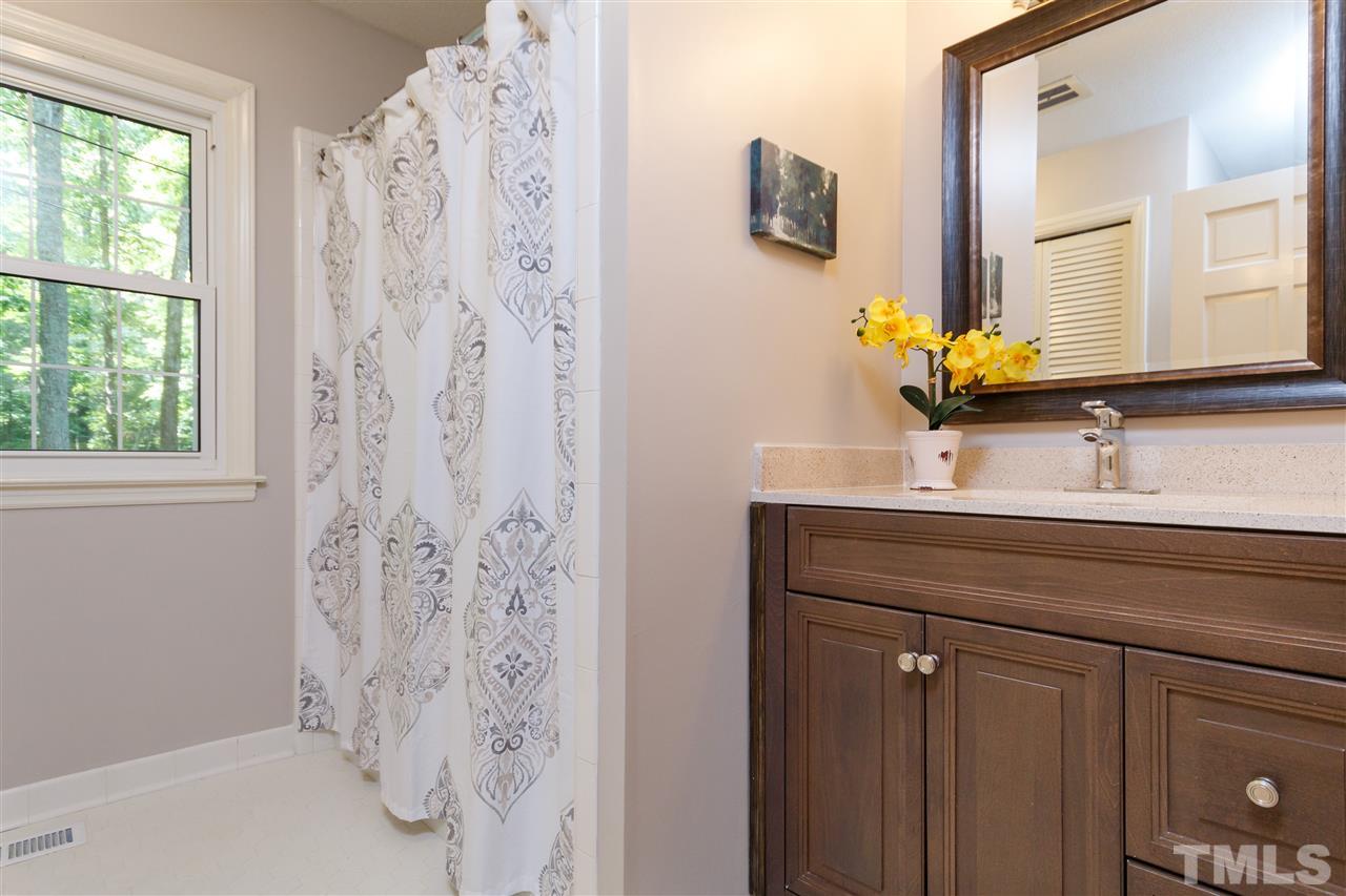 2911 Buckingham Road Durham, NC 27707 - Photo 15 of 25 a bathroom with a sink and a mirror