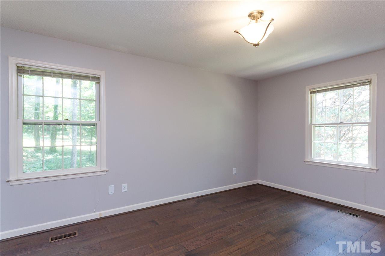 2911 Buckingham Road Durham, NC 27707 - Photo 16 of 25 an empty room with wooden floor and windows