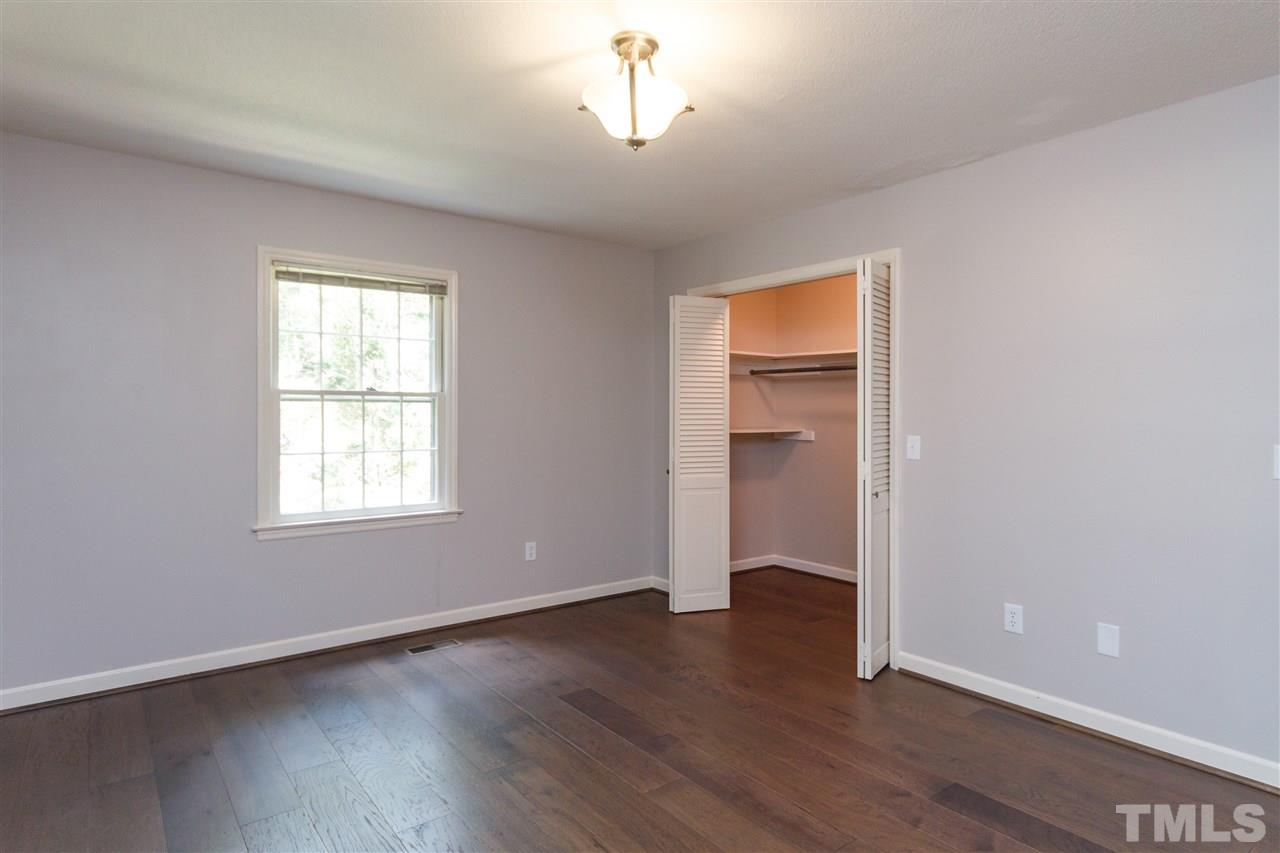 2911 Buckingham Road Durham, NC 27707 - Photo 17 of 25 an empty room with wooden floor cabinet and windows