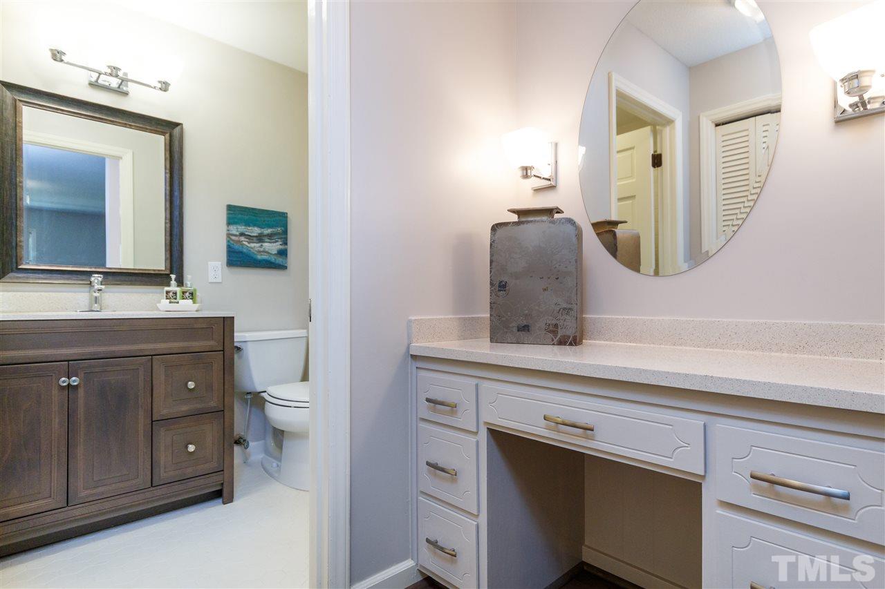 2911 Buckingham Road Durham, NC 27707 - Photo 18 of 25 a bathroom with a toilet sink and mirror