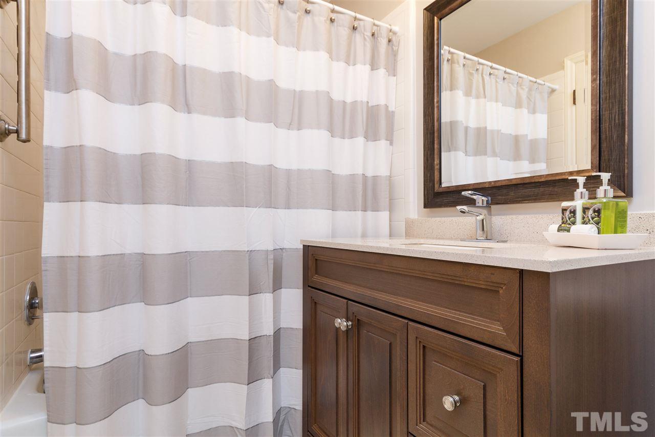2911 Buckingham Road Durham, NC 27707 - Photo 19 of 25 a bathroom with a sink and a mirror