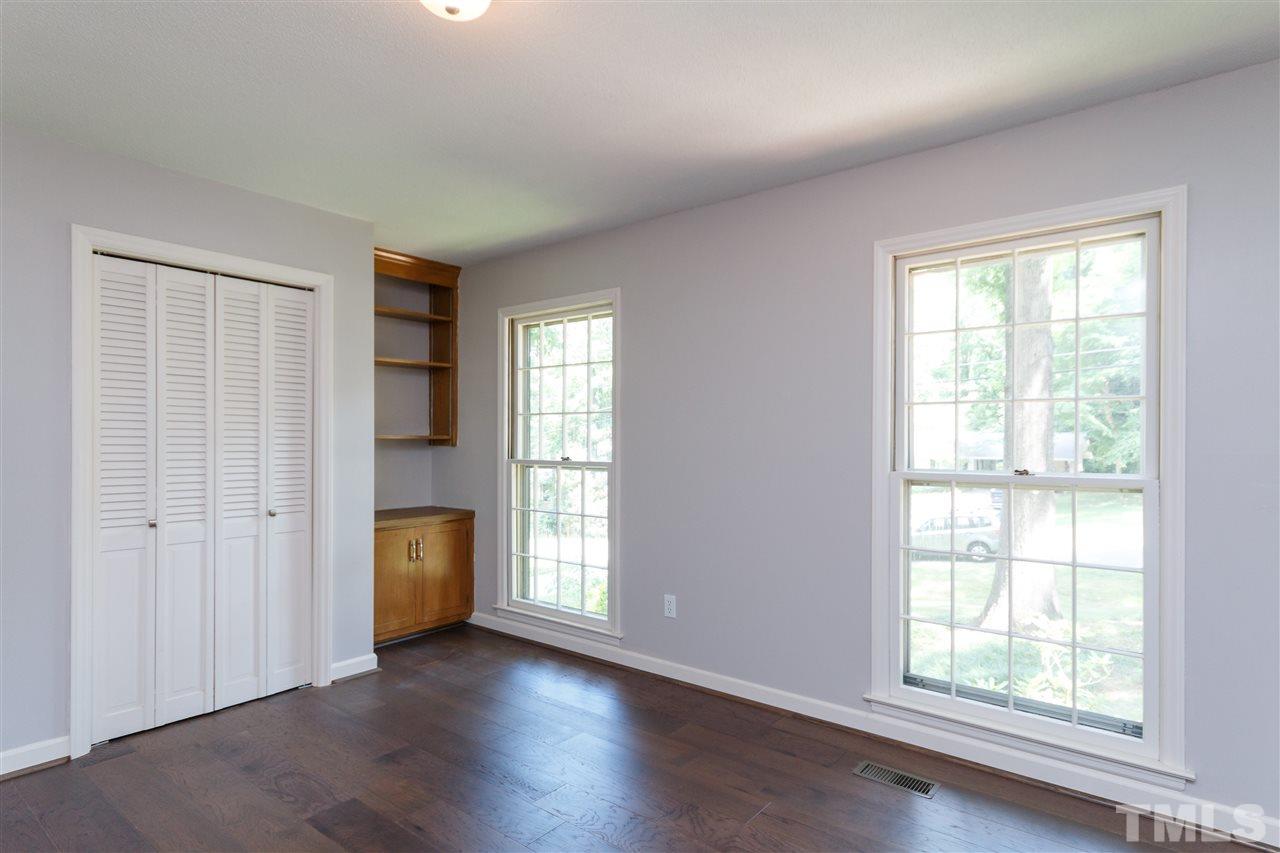 2911 Buckingham Road Durham, NC 27707 - Photo 20 of 25 a view of an empty room with a window and wooden floor