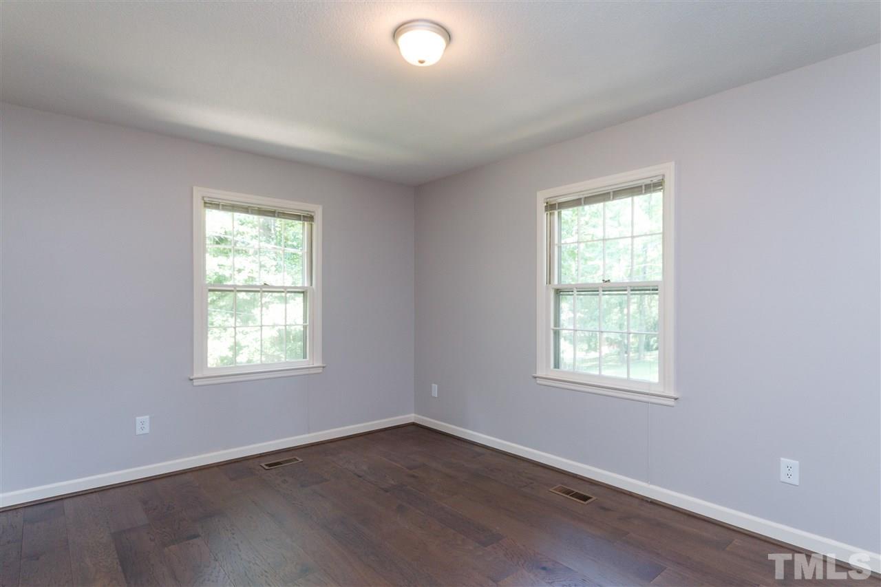 2911 Buckingham Road Durham, NC 27707 - Photo 21 of 25 an empty room with wooden floor and windows