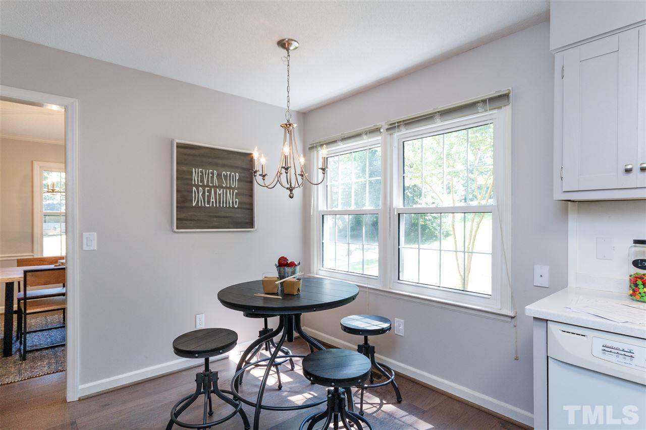 2911 Buckingham Road Durham, NC 27707 - Photo 7 of 25 a view of a dining room with furniture window and wooden floor