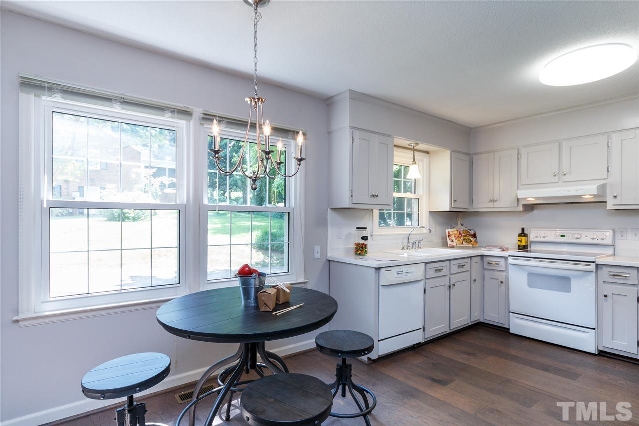 2911 Buckingham Road Durham, NC 27707 - Photo 8 of 25 a kitchen with stainless steel appliances granite countertop a stove a sink and a refrigerator