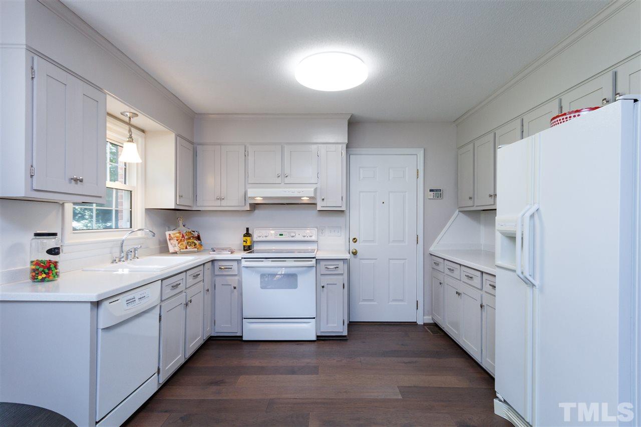 2911 Buckingham Road Durham, NC 27707 - Photo 9 of 25 a kitchen with white cabinets and white appliances