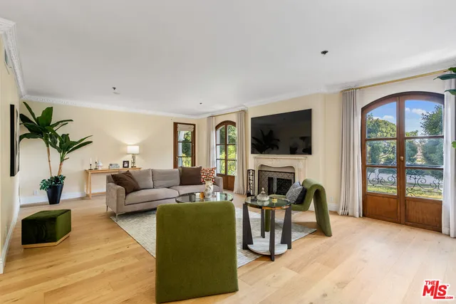 a living room with fireplace furniture and a flat screen tv
