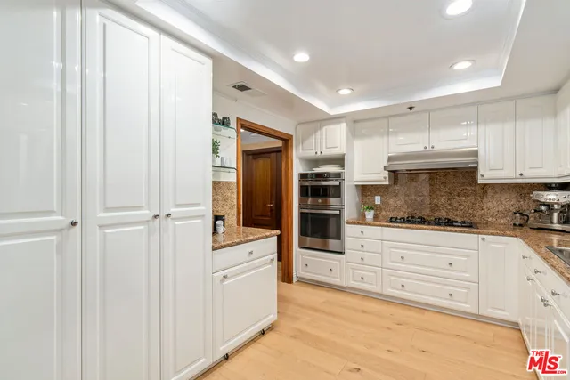 a view of a kitchen with electric appliances