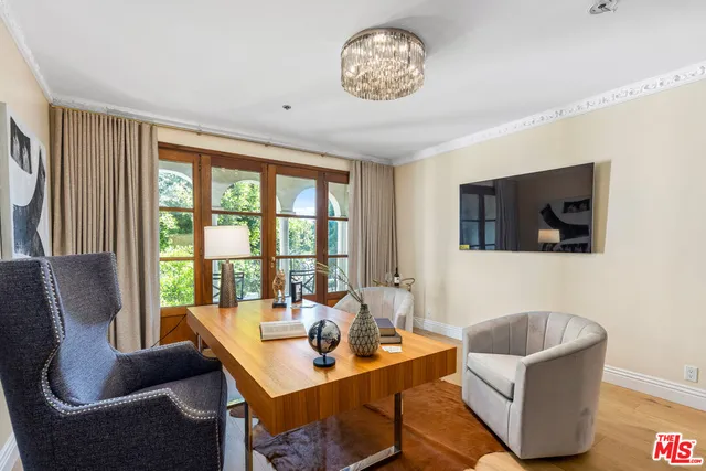 a living room with furniture a flat screen tv and a large window