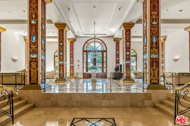 a living room with large mirror and furniture