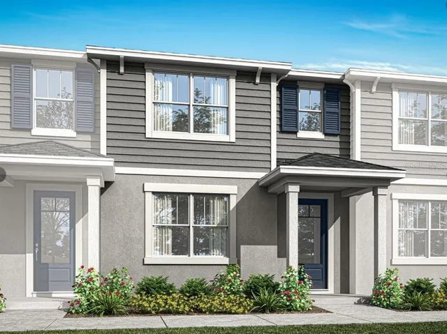front view of a brick house with potted plants