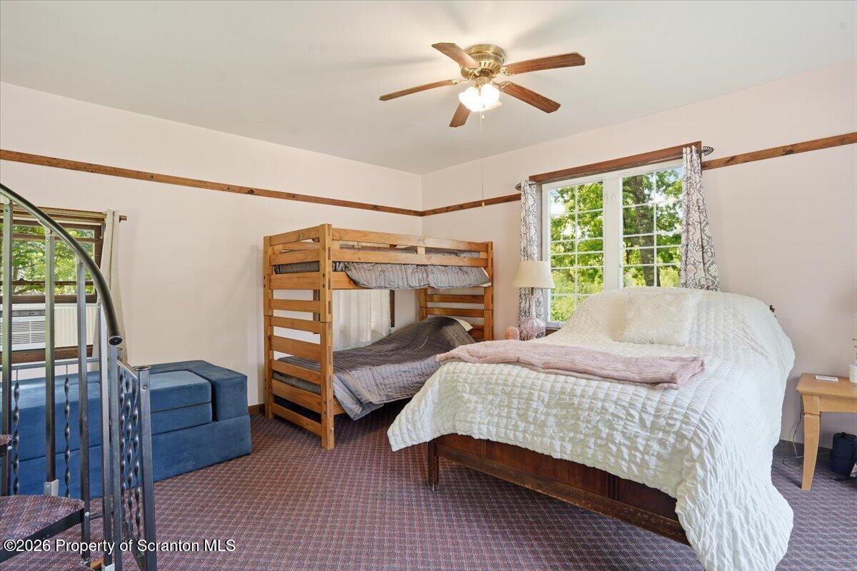 286 North Lk Road Montrose, PA 18801 - Photo 23 of 44 a bedroom with a bed a chandelier and dresser