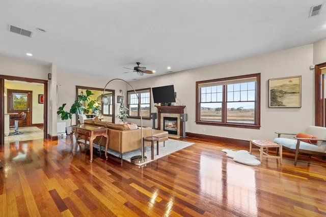 a living room with furniture and a wooden floor