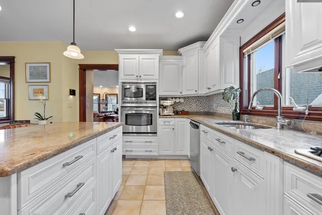 a kitchen with stainless steel appliances granite countertop a sink and cabinets