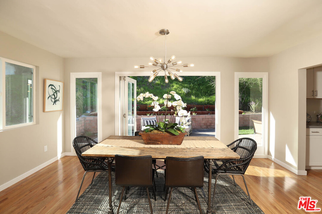 a view of a dining room with furniture wooden floor and chandelier