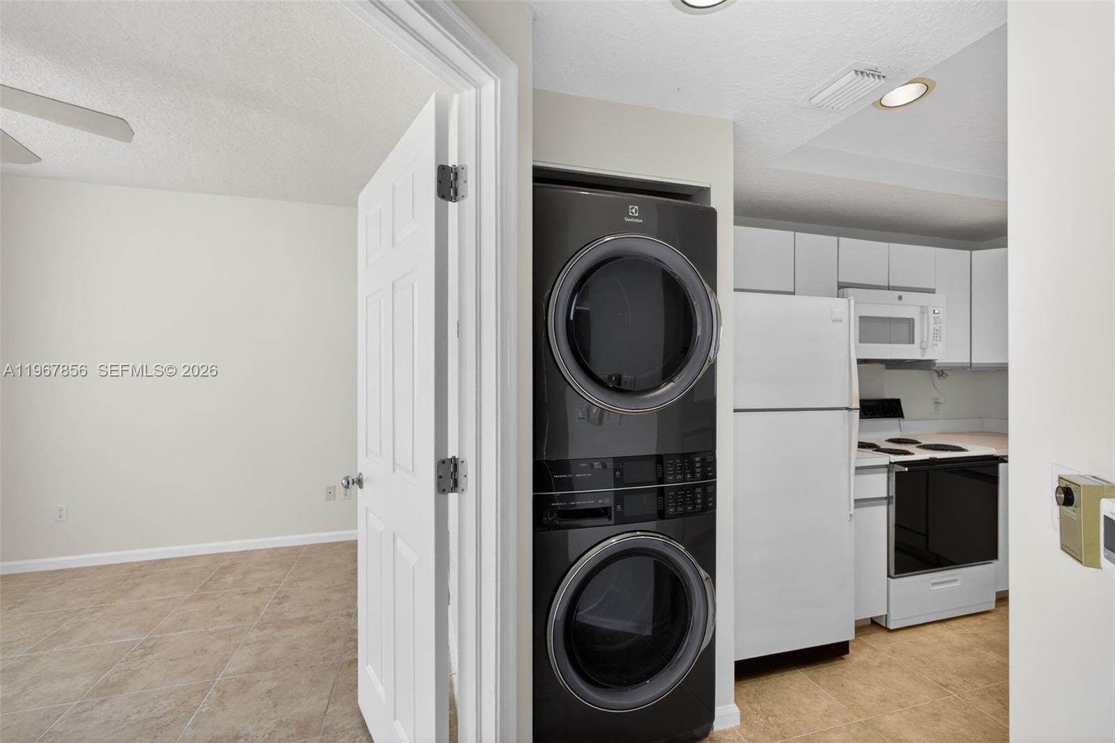 101 Muirfield Court, Unit 101D Jupiter, FL 33458 - Photo 11 of 62 a view of a kitchen with a washer and dryer