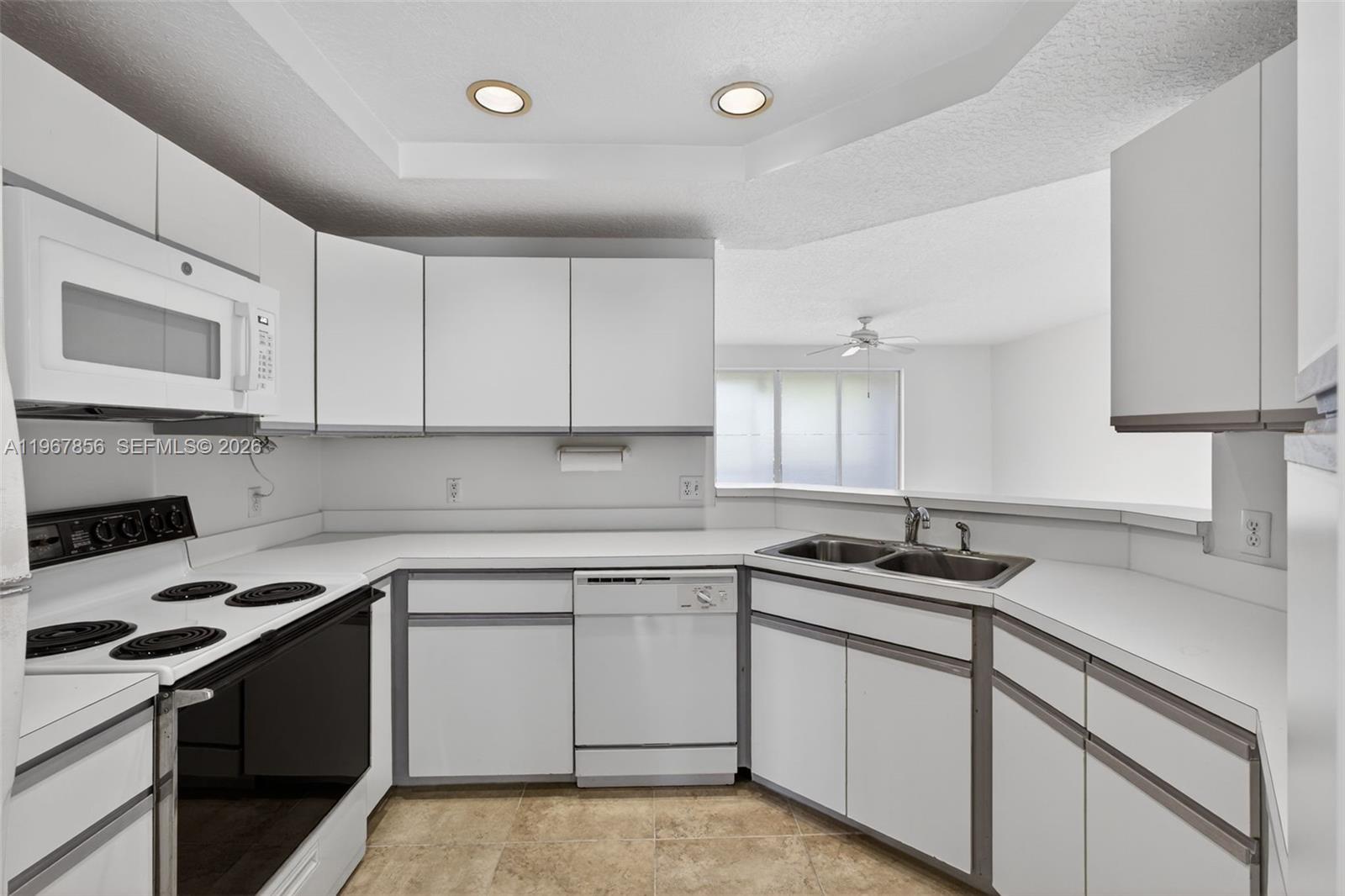 101 Muirfield Court, Unit 101D Jupiter, FL 33458 - Photo 12 of 62 a kitchen with a sink stove and cabinets