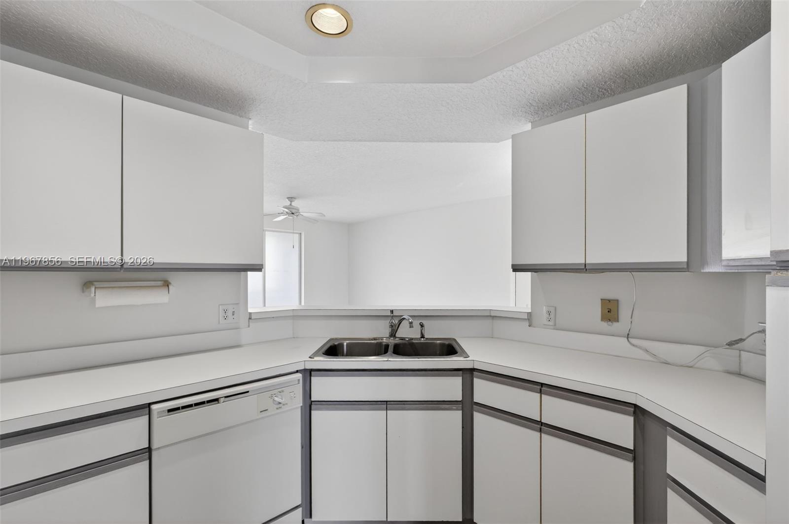 101 Muirfield Court, Unit 101D Jupiter, FL 33458 - Photo 13 of 62 a kitchen with cabinets appliances a sink and a counter top space