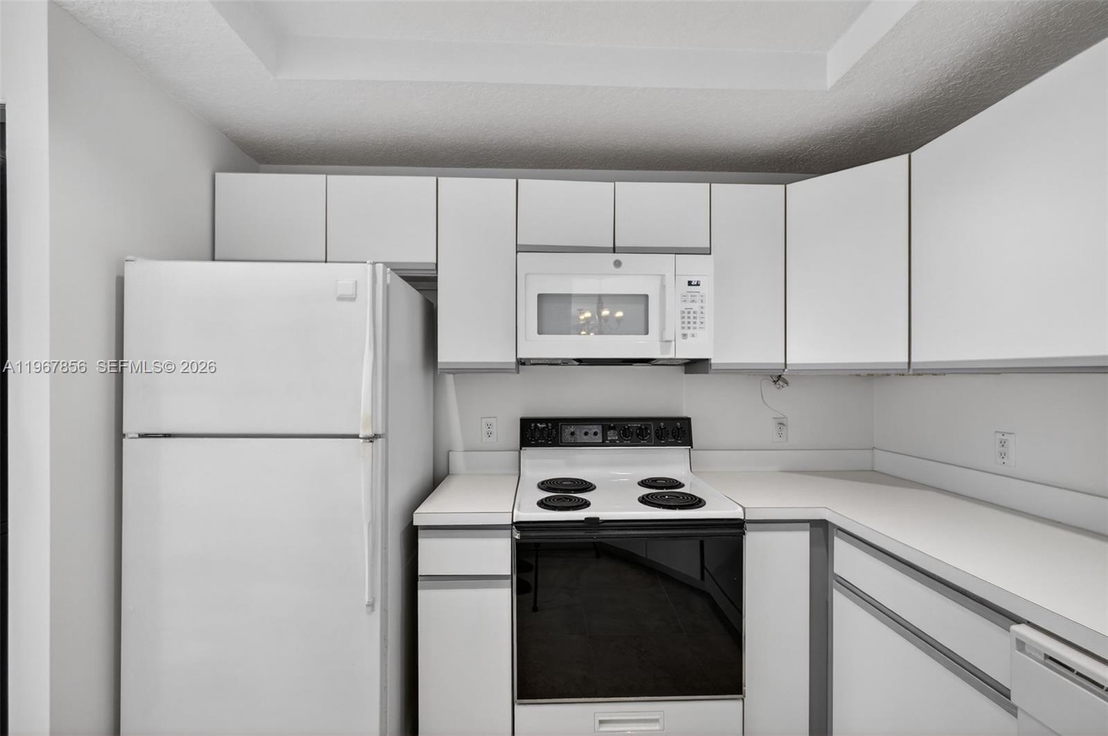 101 Muirfield Court, Unit 101D Jupiter, FL 33458 - Photo 14 of 62 a white refrigerator freezer sitting in a kitchen