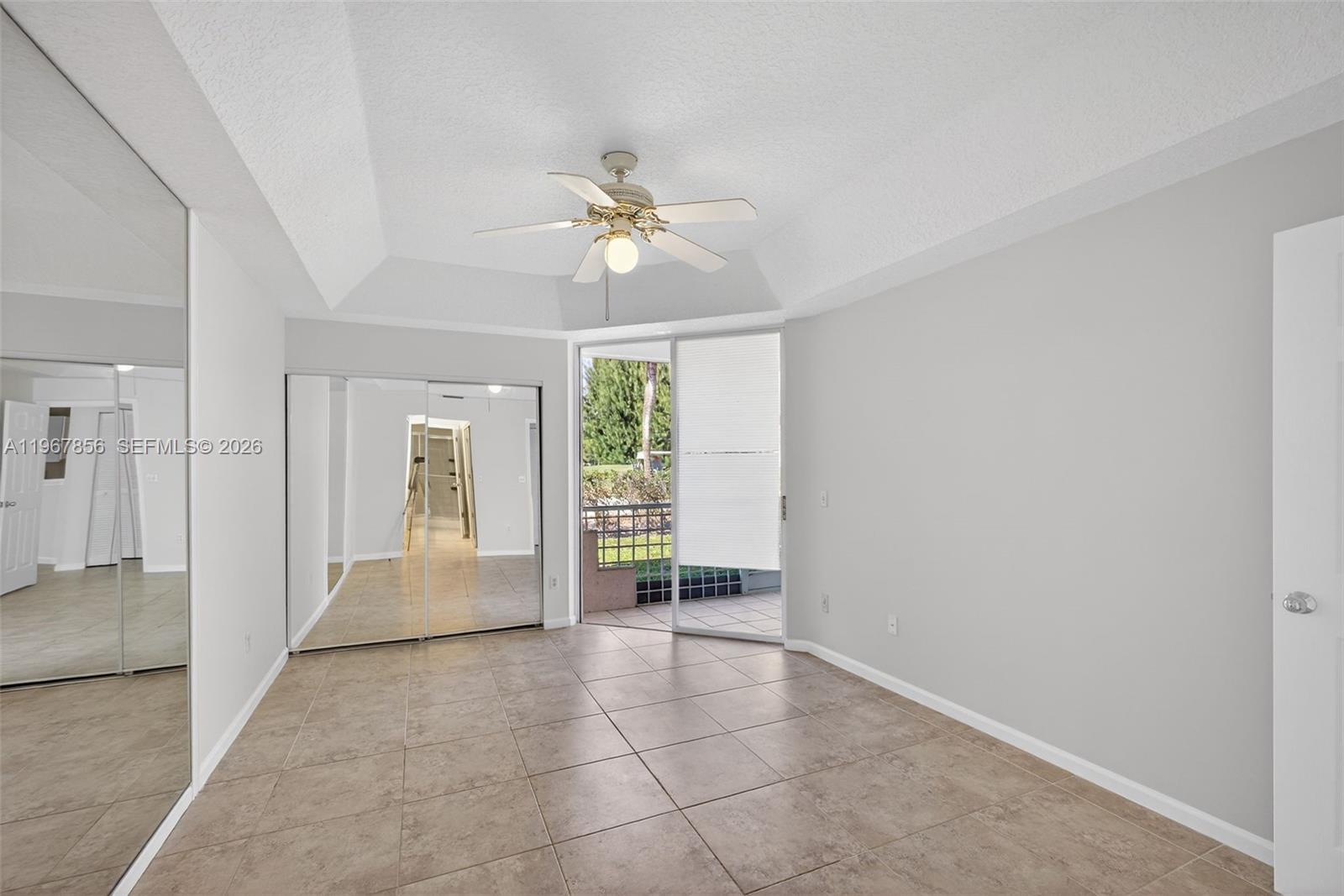 101 Muirfield Court, Unit 101D Jupiter, FL 33458 - Photo 16 of 62 en empty room with windows and fan